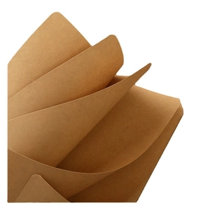 Minimalist kraft paper notebook with a sewn spine shown in stacked arrangement