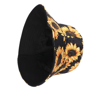 Detail view of sunflower bucket hat showing black twill cotton and floral print texture