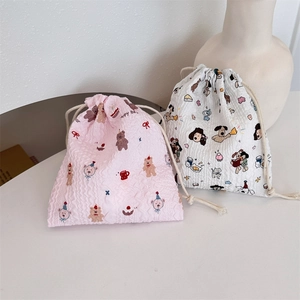 Detail of pink bear and white cartoon drawstring bags with bubble ripple texture fabric