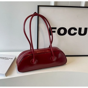 Detail view of the sleek deep red PU leather shoulder bag with glossy finish and dual straps