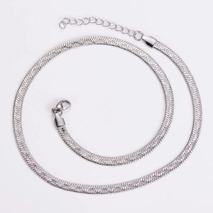 Detailed macro view of silver flat snake chain with lobster clasp and extender