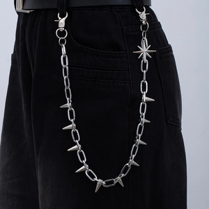 Silver punk pants chain with metallic spikes and octagram pendant on dark jeans