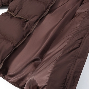 Close-up of metal zipper and adjustable waist drawstring on brown padded winter jacket