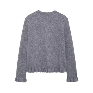 Detail of grey knit cardigan showing ruffle trim on cuffs and hem with button-up front