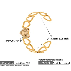 Detailed view of hollow heart stainless steel bracelet with white zircon inlay