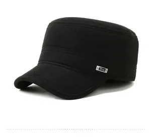Detail of black winter flat cap featuring ribbed texture fabric and T-S metal badge