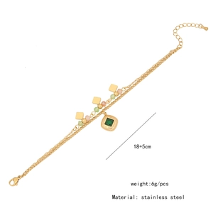 Detail of double-layer stainless steel bracelet with green gem and crystal beads