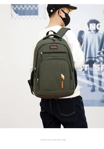 Detail view of large army green business backpack with multi-layer zippers and side mesh pocket