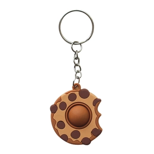 Chocolate cookie keychain with bubble fidget toy and metal ring on white background