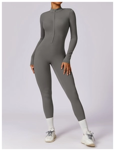 Detail of grey athletic jumpsuit showing zipper neckline and high-elastic compression fabric