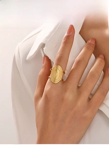 Macro shot of 18K gold plated oval ring with radial textures and double-row band