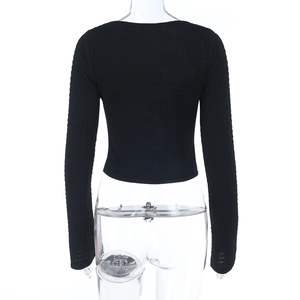 Close-up of black long sleeve backless crop top with lace-up detail and knit texture