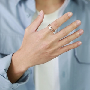 Close-up of a tricolor striped stainless steel ring worn on a finger for men