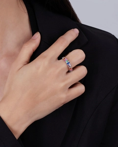 Macro shot of 925 silver ring with rainbow rectangle gemstones worn on hand
