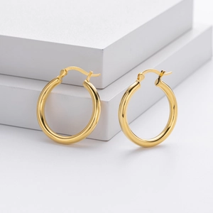 Detail view of gold S925 sterling silver hoop earrings with clear hallmark engraving