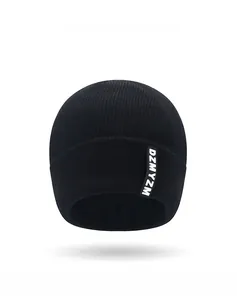 Detailed close-up of black knitted beanie showing soft ribbed texture and letter patch