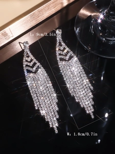 Detailed view of silver tassel earrings with measurements 9cm length and 1.8cm width