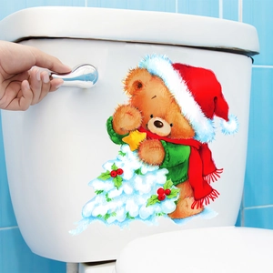 Close-up of a Christmas cartoon bear sticker applied on a white toilet tank surface