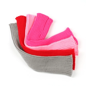 Detailed knit texture of loose leg warmers in grey, red, pink and fuchsia colors