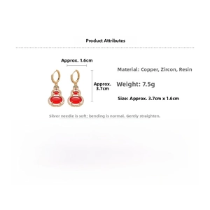 Detail view of 14k gold-plated gourd earrings with red resin and green zircon stones