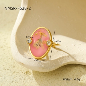 Detail view of pink resin ring with dried flowers, gold foil, and size measurements