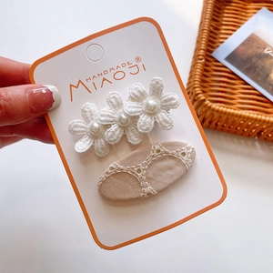 Close-up of matcha green bow hair clips with lace flowers and pearl details