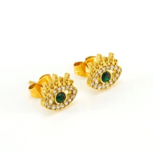 Macro shot of gold evil eye earrings with green zirconia and sparkling white stones
