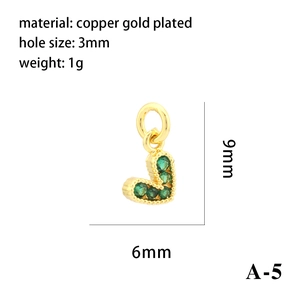 Macro shot of 18K gold plated heart pendant with green zircon and size dimensions