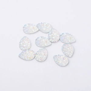 Macro view of 10 white iridescent resin water drop beads with sparkling glitter finish