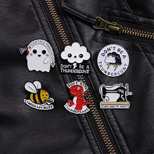 Artistic set of 6 enamel pins featuring cartoon ghost, bee, and cloud on black leather jacket