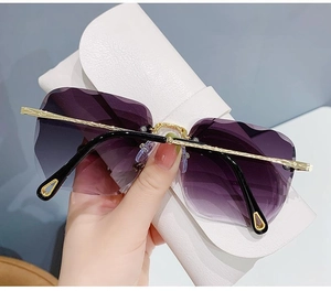 Detail view of purple gradient rimless sunglasses with gold metal temples and drip tips