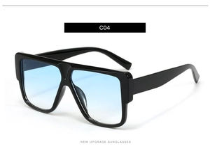 Detail shot of square oversized sunglasses with black frame and blue gradient lens