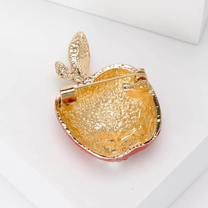 Golden red apple brooch back detail with high-quality metal base and secure pin clasp