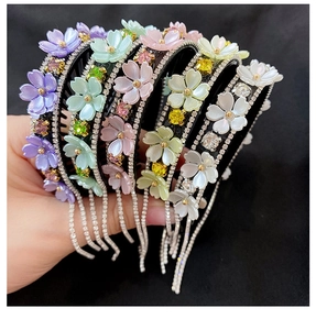 Detail showing colorful flower hair clips with sparkling rhinestone tassels and crystals