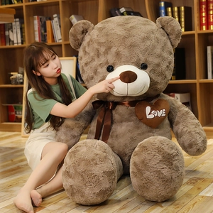 Detailed view of giant brown rose velvet teddy bear plush with Love heart embroidery