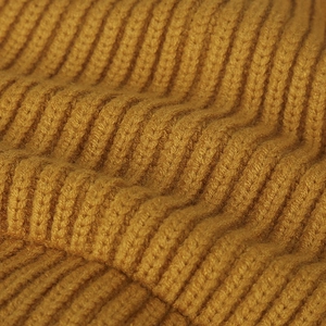 High-quality macro detail of mustard yellow ribbed knit fabric texture for winter beanie