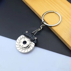 Close-up of industrial metal keychain featuring a realistic car brake disc and caliper design