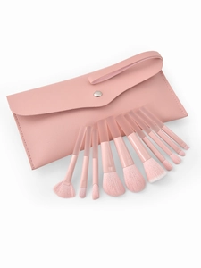 Detailed close-up of 9-piece peach pink makeup brush set with a textured PU leather pouch