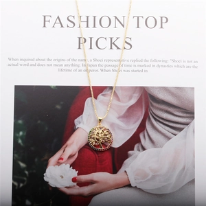 Detail of gold tree of life pendant with colorful zircon crystals on a fine chain