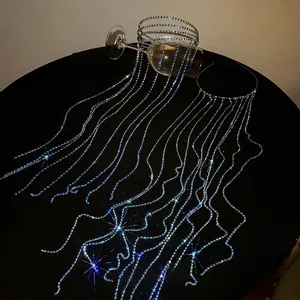 Elegant luxury headband featuring long blue rhinestone tassels on a sleek metal frame