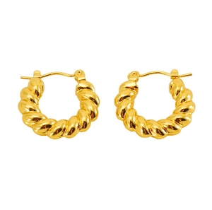 Close-up of golden twisted rope hoop earrings with a polished croissant style texture