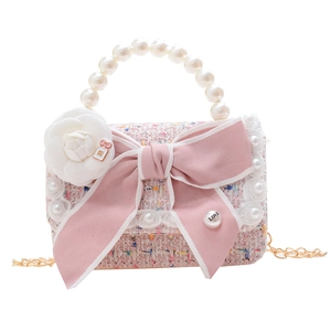 Pink tweed girls handbag with pearl handle and ribbon bow in a stylish mini crossbody design
