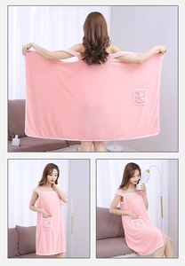 Pink coral fleece wearable bath towel detail featuring shoulder straps and a bow pocket