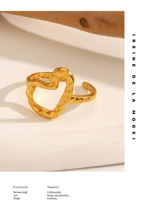 Detail of gold heart ring with hammered texture and adjustable open band design