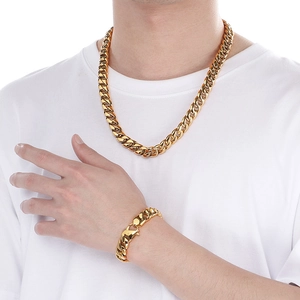 Close-up of a 12mm gold-plated Cuban link chain necklace and bracelet set on a model