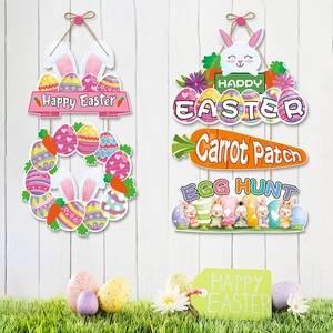 Happy Easter hanging door signs with bunny ears and carrots on white wood wall