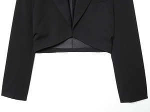 Detail of black cropped blazer featuring padded shoulders and tailored notch lapels