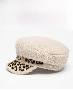 Detail view of winter baker boy hat with beige sherpa fleece and leopard print brim