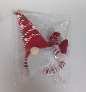 Close-up of a Christmas gnome doll with a red sequin hat in clear plastic packaging