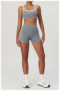 Detail view of grey two-piece yoga set with white contrast piping and functional seams